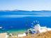 A view of a seafront windmill on the island of Thirasia in Greece