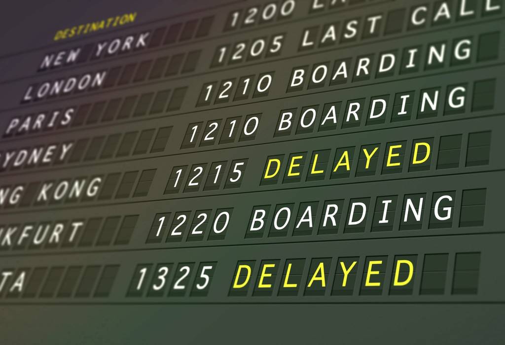 Flight delayed board showing numerous flight routes either cancelled or delayed