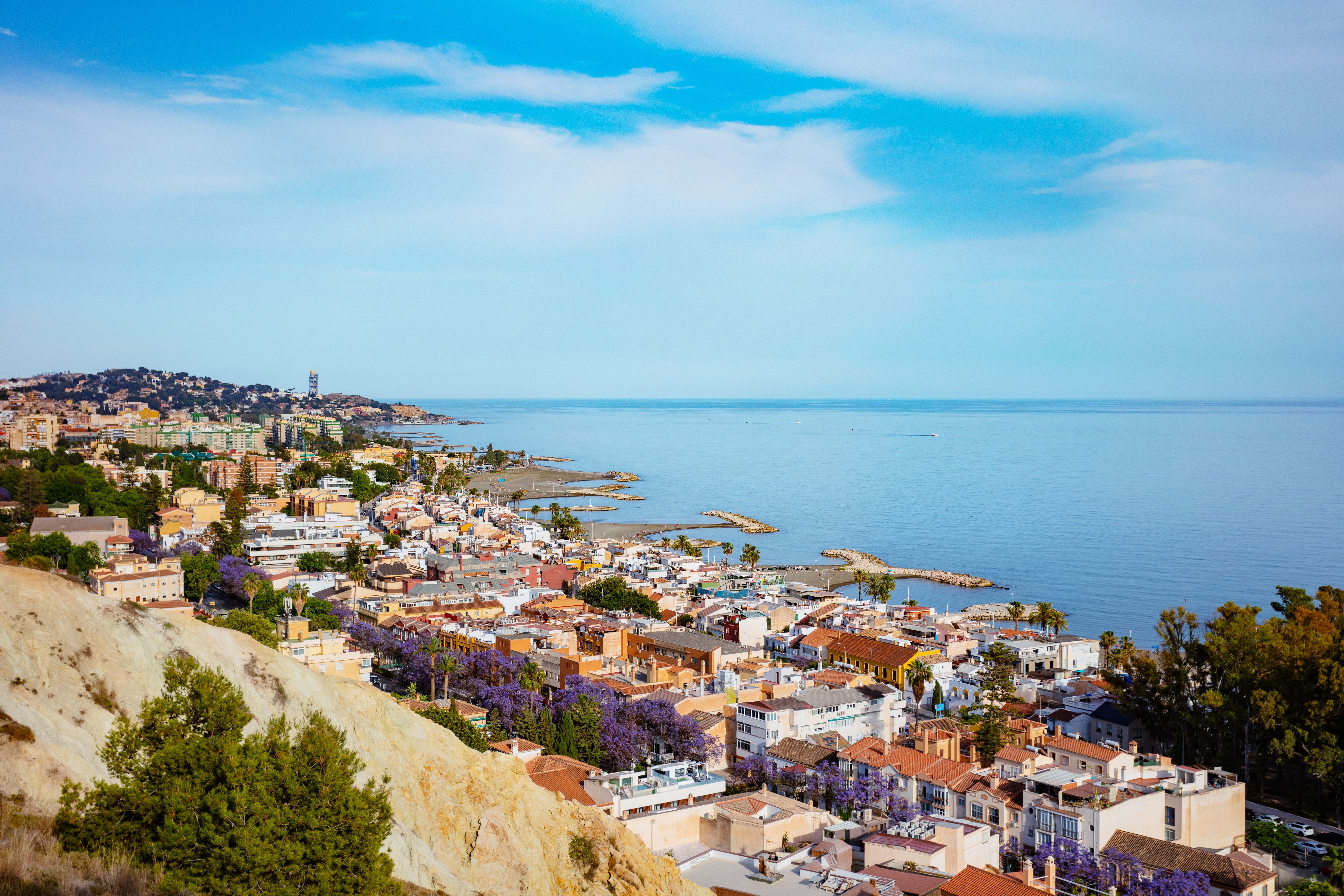 Aerial view of a string of horseshoe-shaped beaches along the coast of Malaga