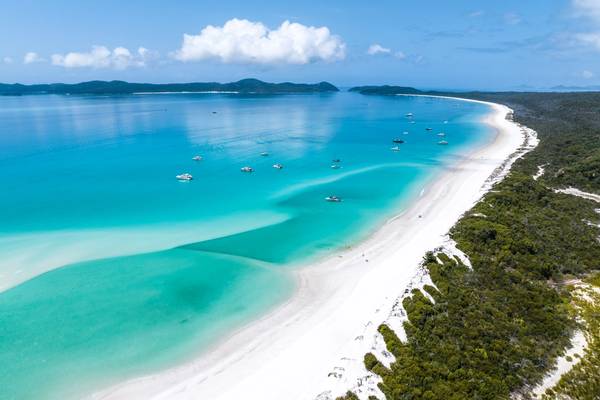 high angle aerial drone view of Whitehaven Beach with a bright blue ocean and white sands, Queensland, Australia