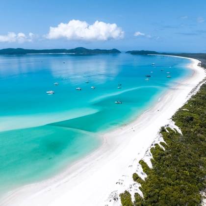 high angle aerial drone view of Whitehaven Beach with a bright blue ocean and white sands, Queensland, Australia