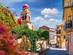 Colourful buildings and a red-domed bell tower on a sunny day in Kerkyra, Corfu