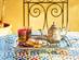 Traditional Moroccan mint tea with sweets on a mosaic cafe table