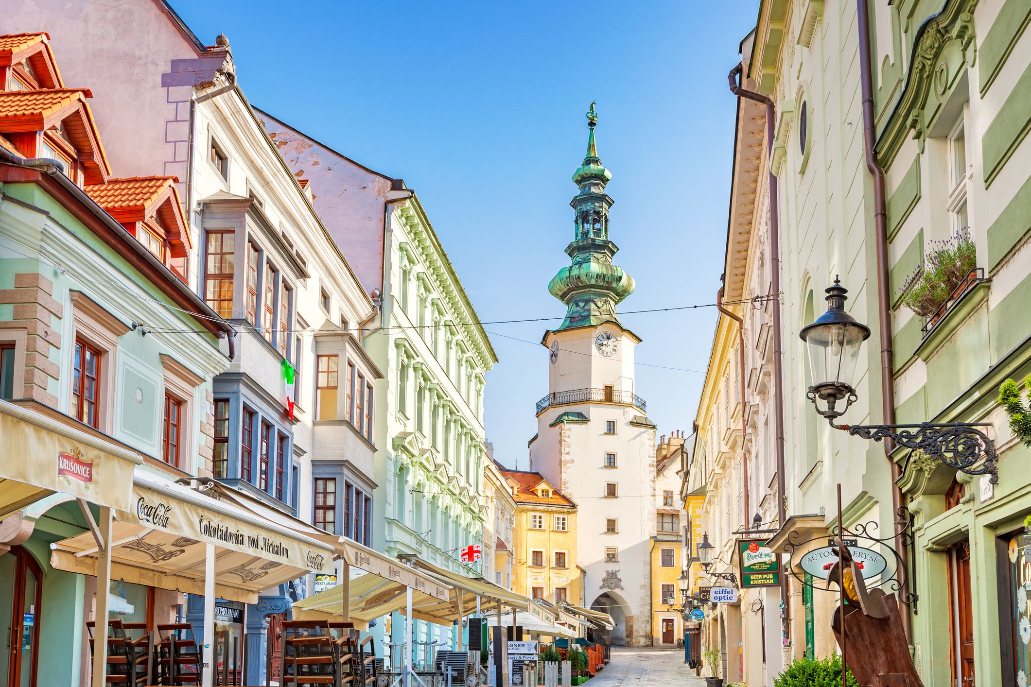 A close up view of an alley with stores and restaurants in old town Bratislava, Slovakia.