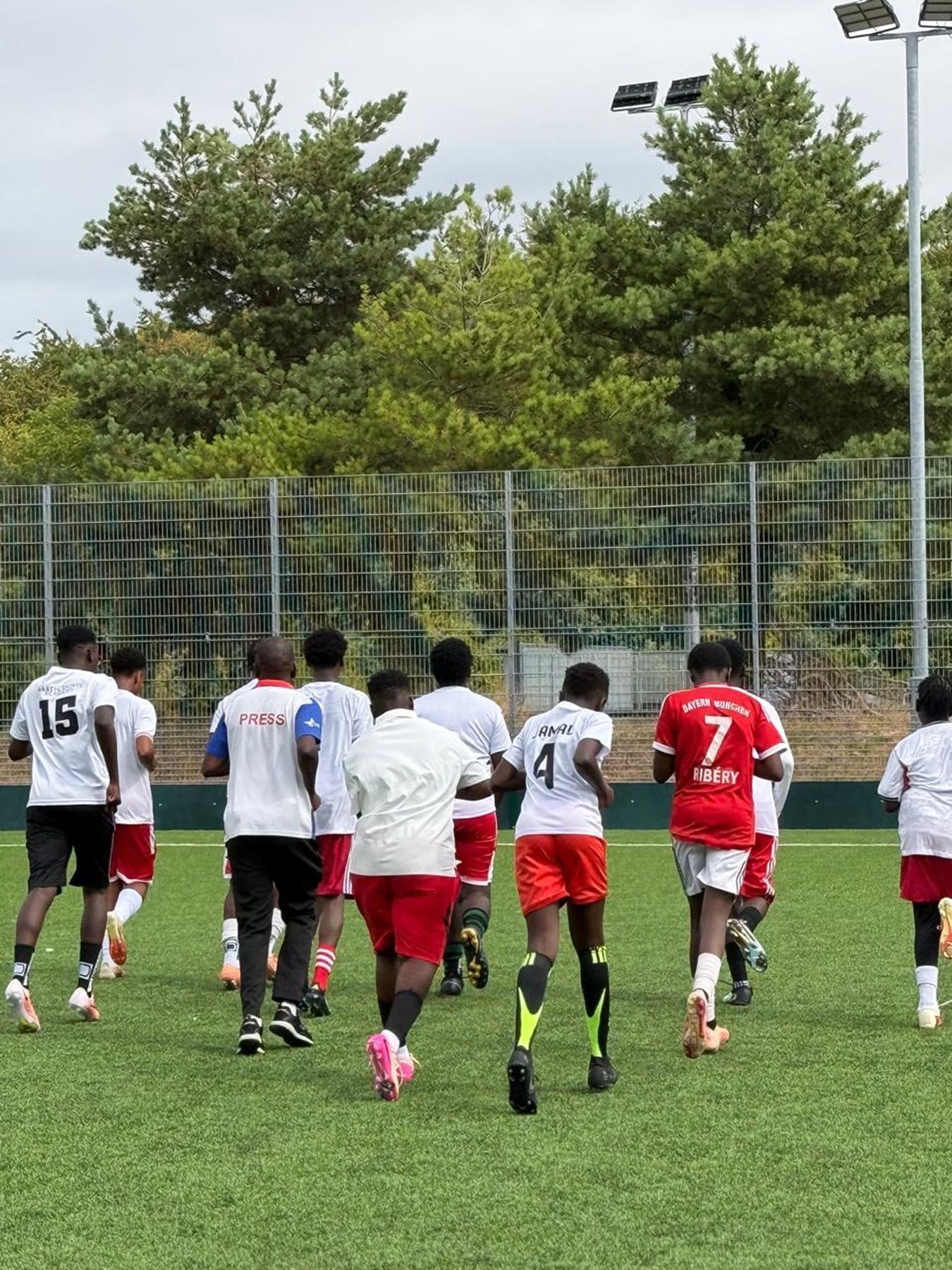 Students warming up together on a football pitch