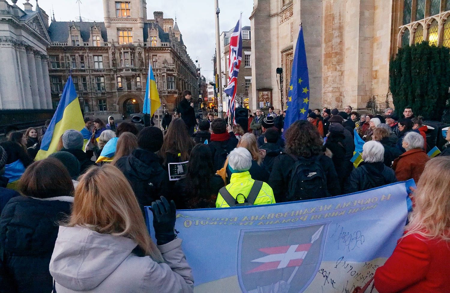 People with Ukrainian flags at the 24 February demonstration on King's Parade, Cambridge
