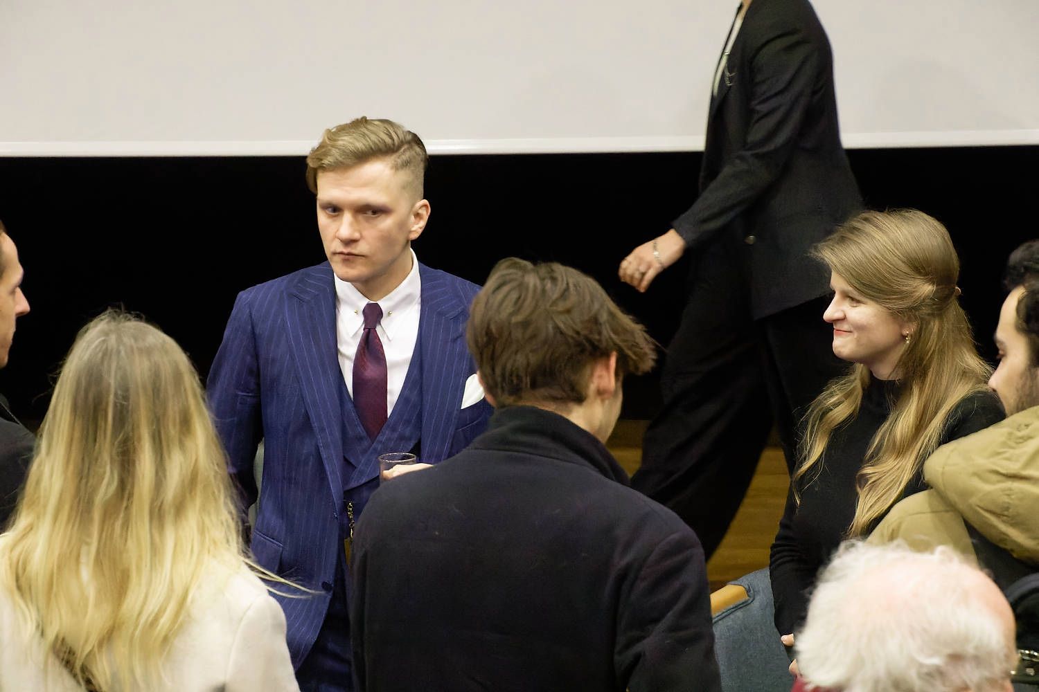 Guests mingling at a CUUS evening event in a lecture theatre