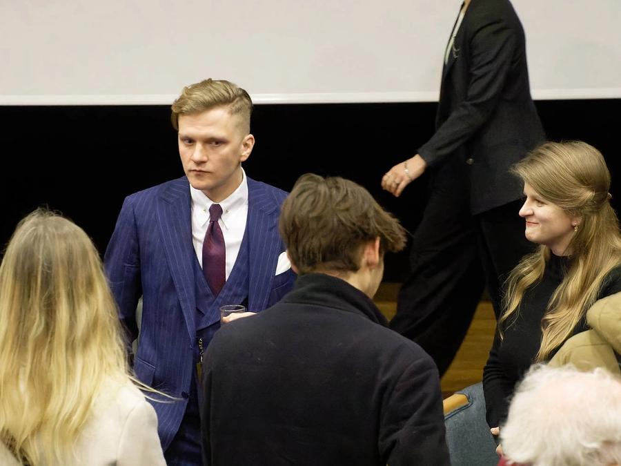 Guests mingling at a CUUS evening event in a lecture theatre