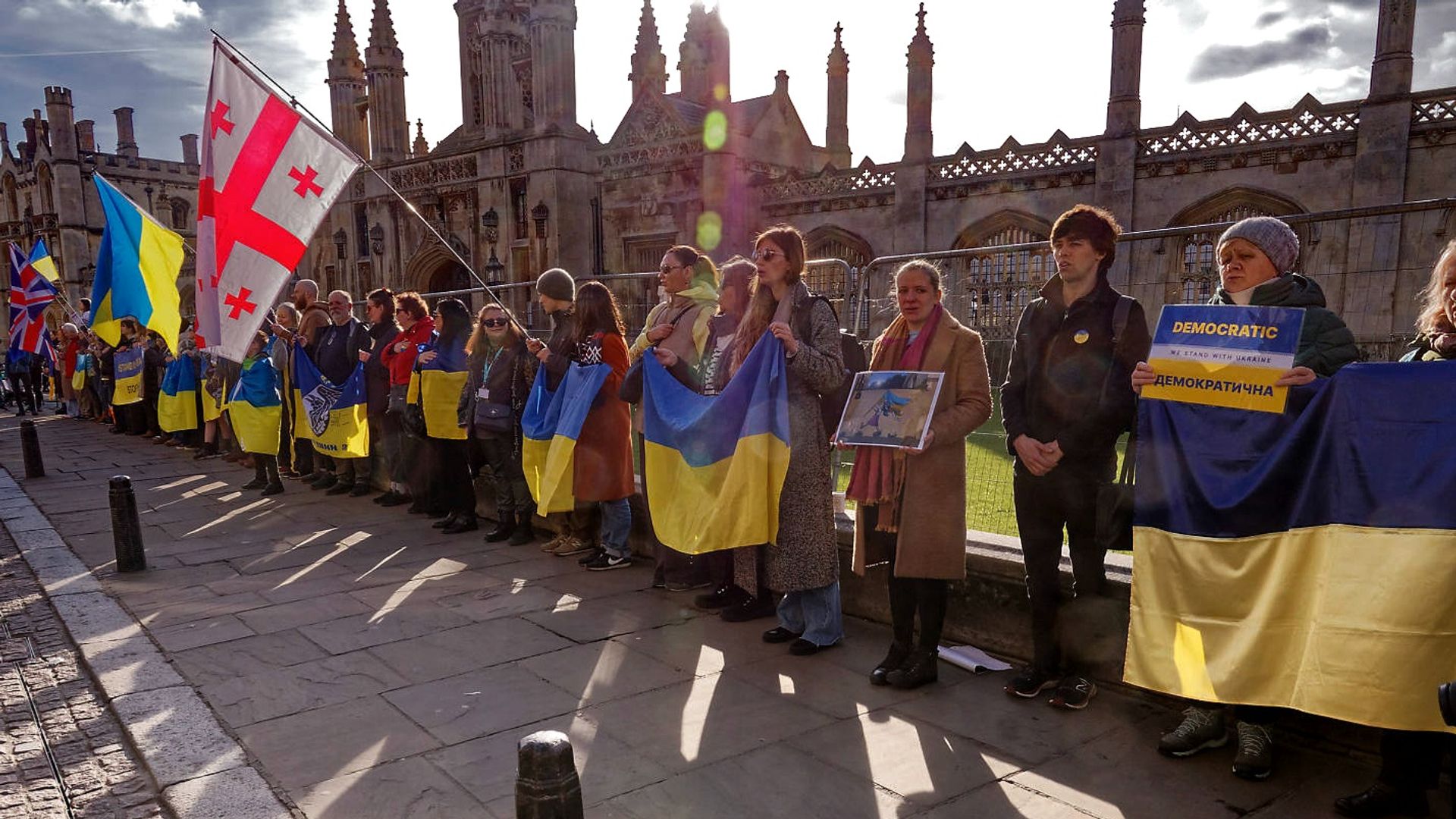 Supporters holding Ukrainian flags outside King’s College, Cambridge