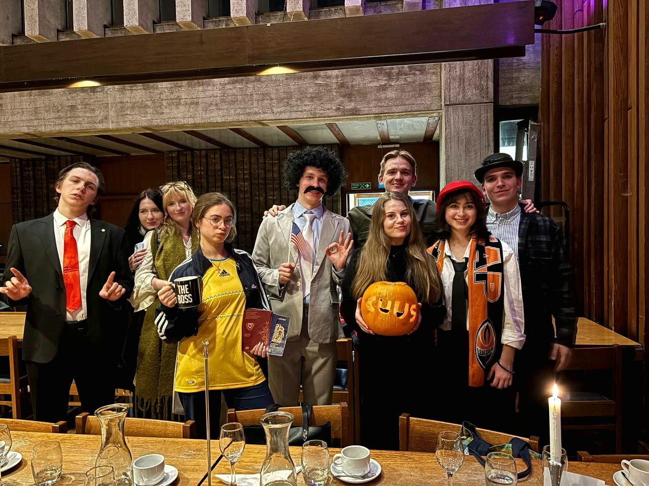 CUUS members in costume at the Halloween social, with a carved CUUS pumpkin