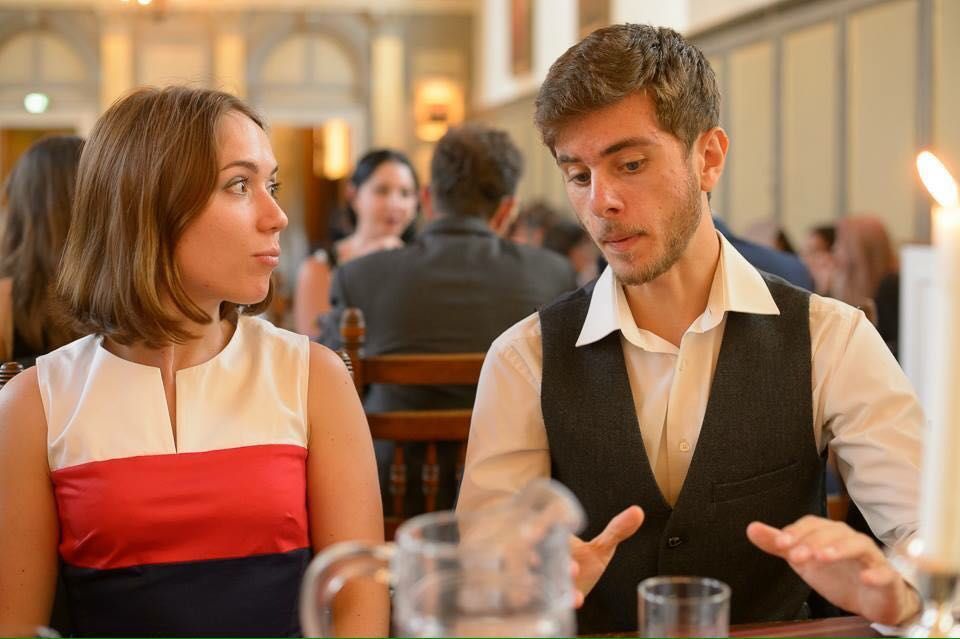 Two CUUS committee members in conversation at a formal dinner