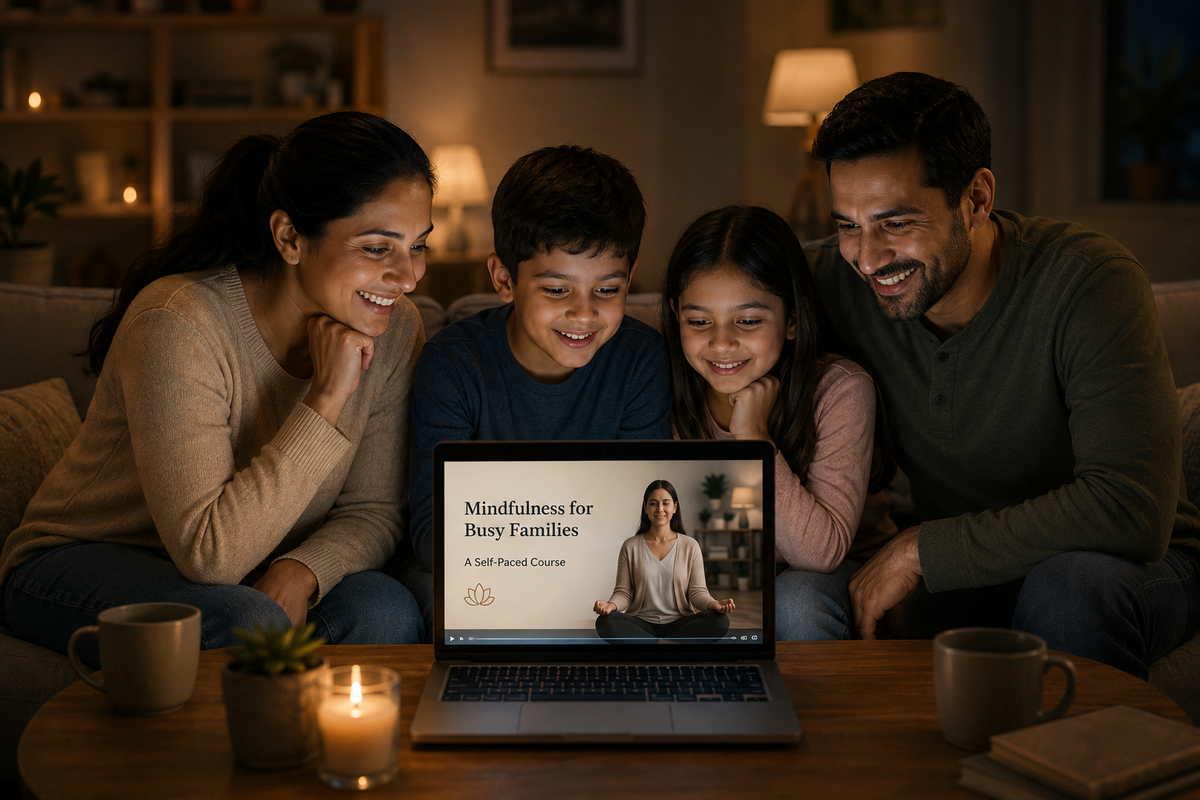 A family gathered together watching a mindfulness course on a laptop in warm evening home lighting