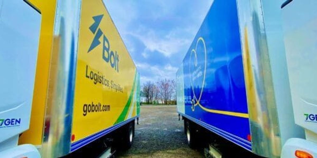 Side-by-side comparison of leased and owned electric delivery vans in a fleet depot with charging stations