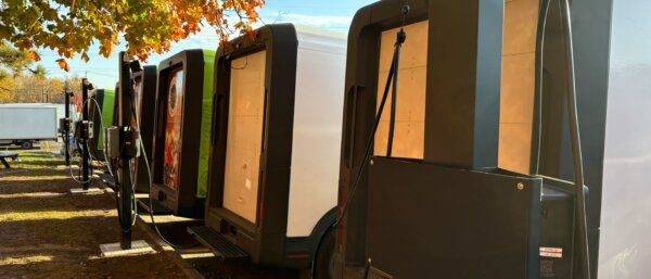 Electric delivery vans parked at a distribution hub illustrating sustainable last-mile delivery