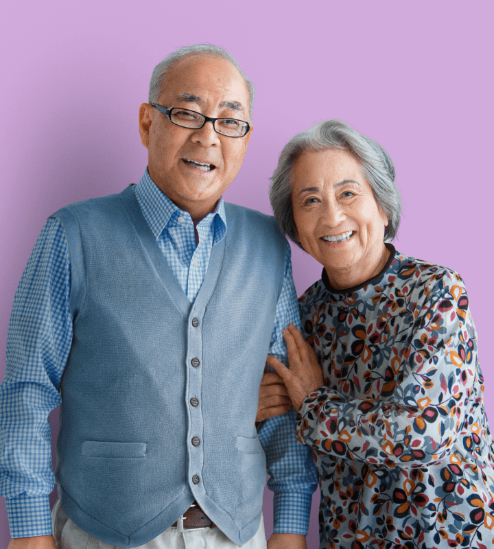 Couple smiling on purple background