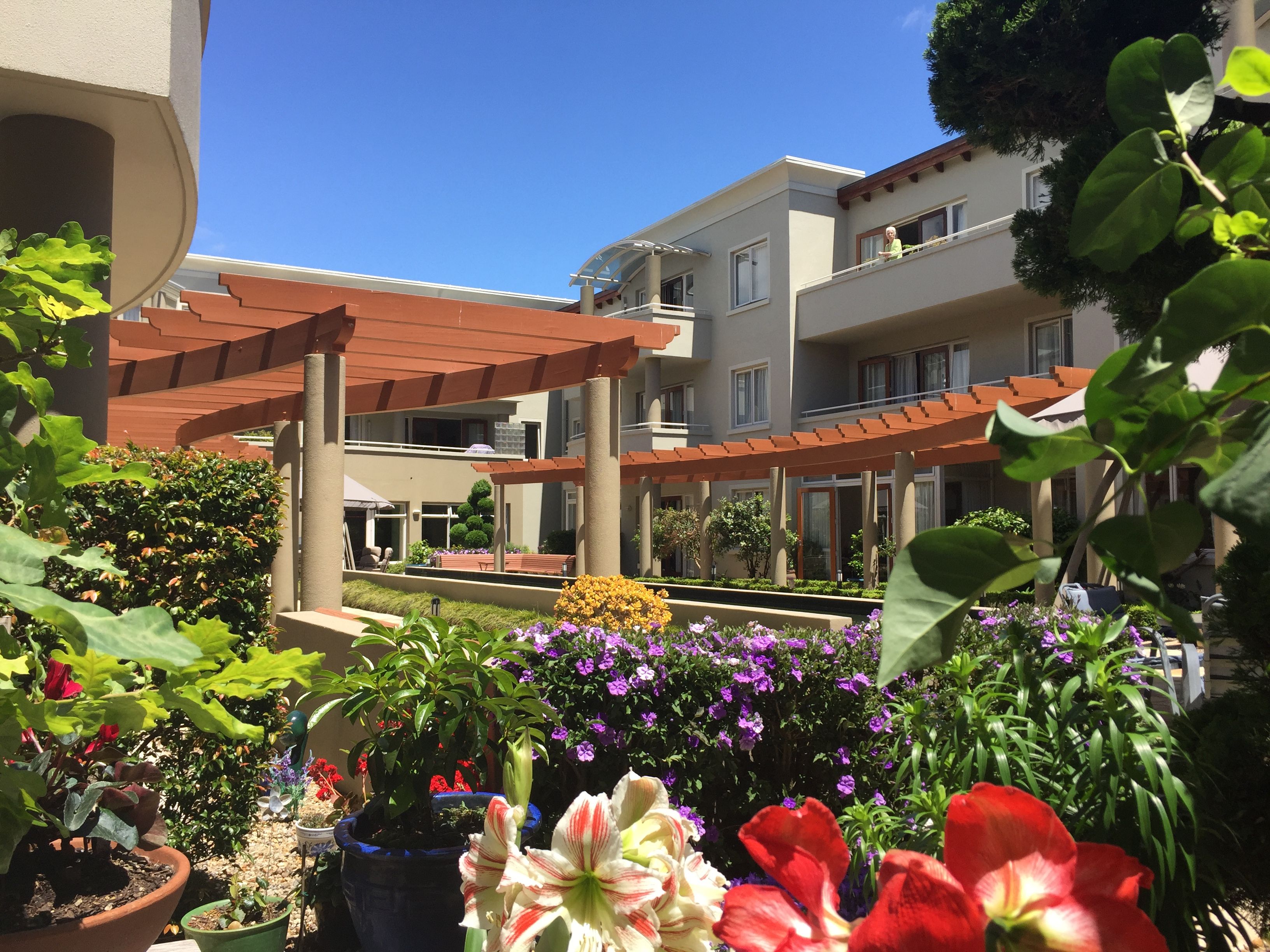 The Avenues and lovely flowers next to apartment. 
