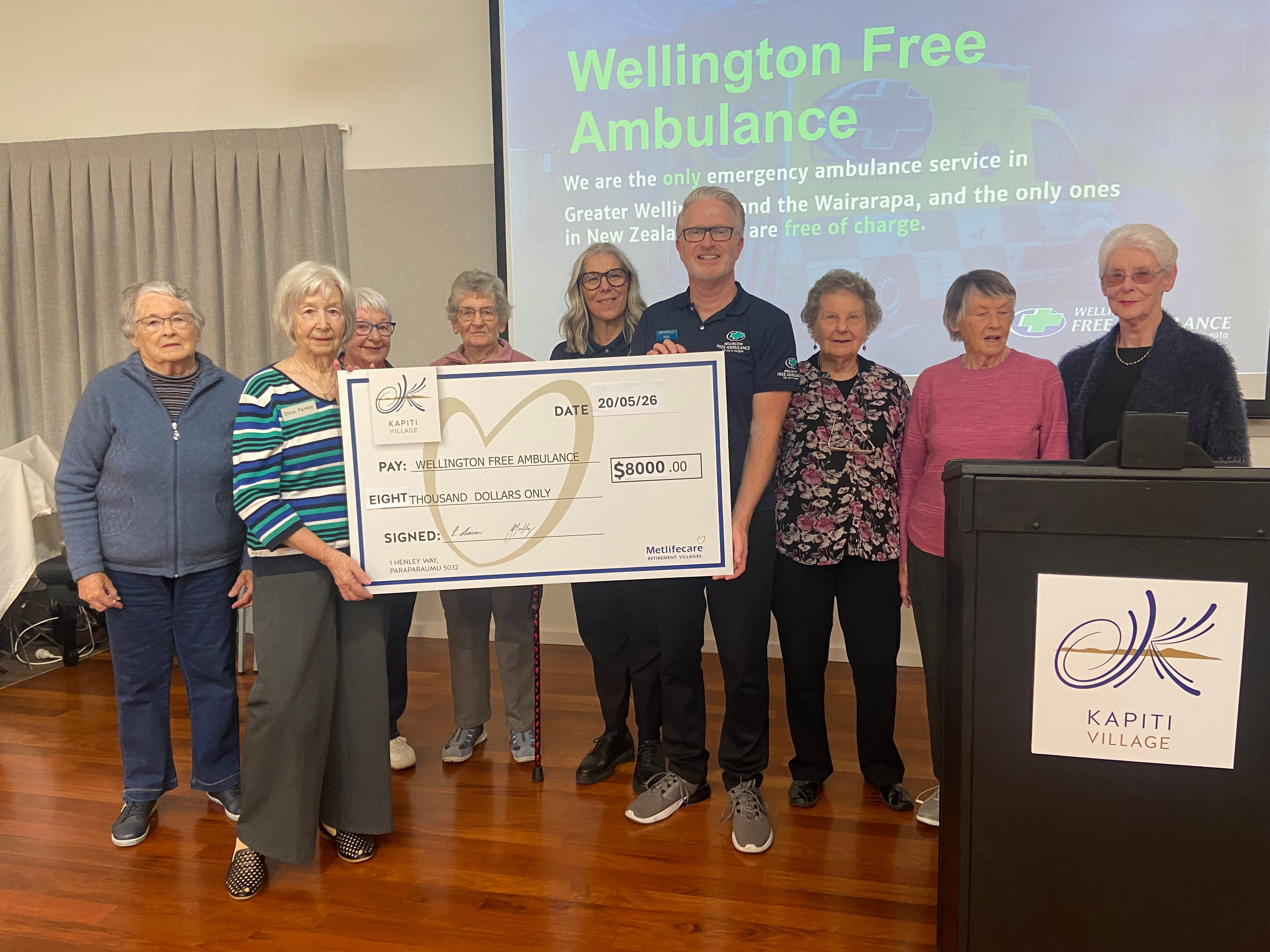 Kāpiti Village residents present a giant cheque to Wellington Free Ambulance