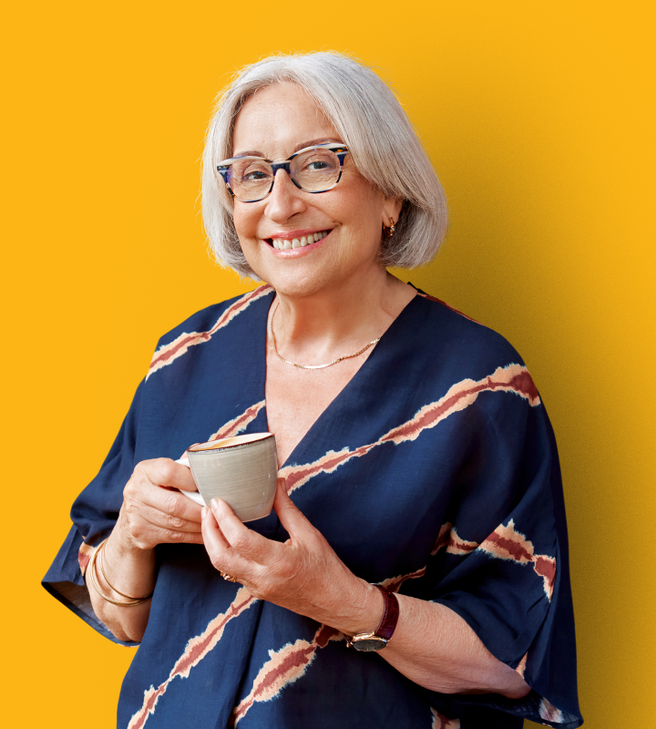 Resident smiling with a cup pf tea