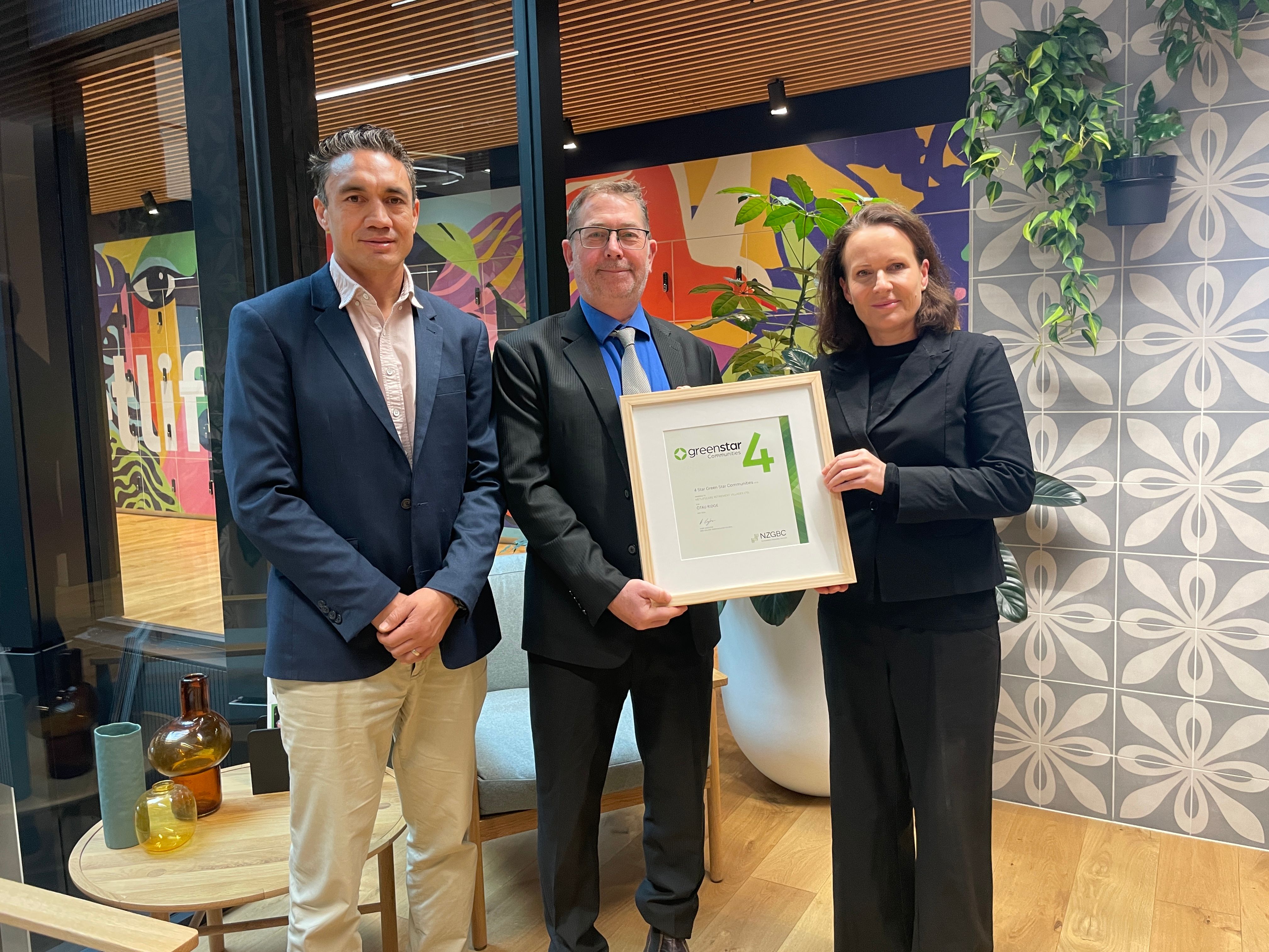 Joe Bartley and Hannah Walton receive certificate from Brad Crowley at NZGBC