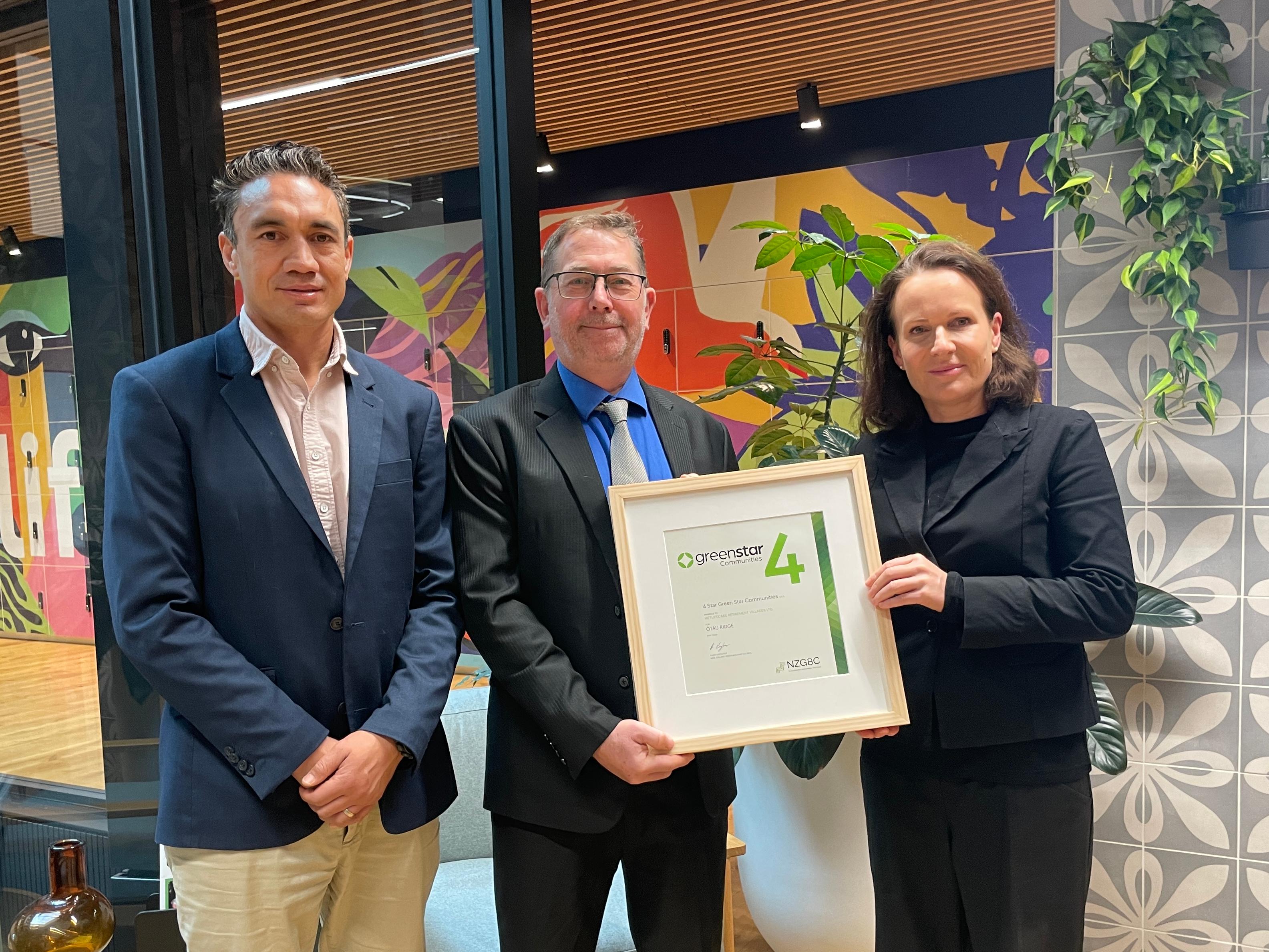 Joe Bartley and Hannah Walton receive certificate from Brad Crowley at NZGBC
