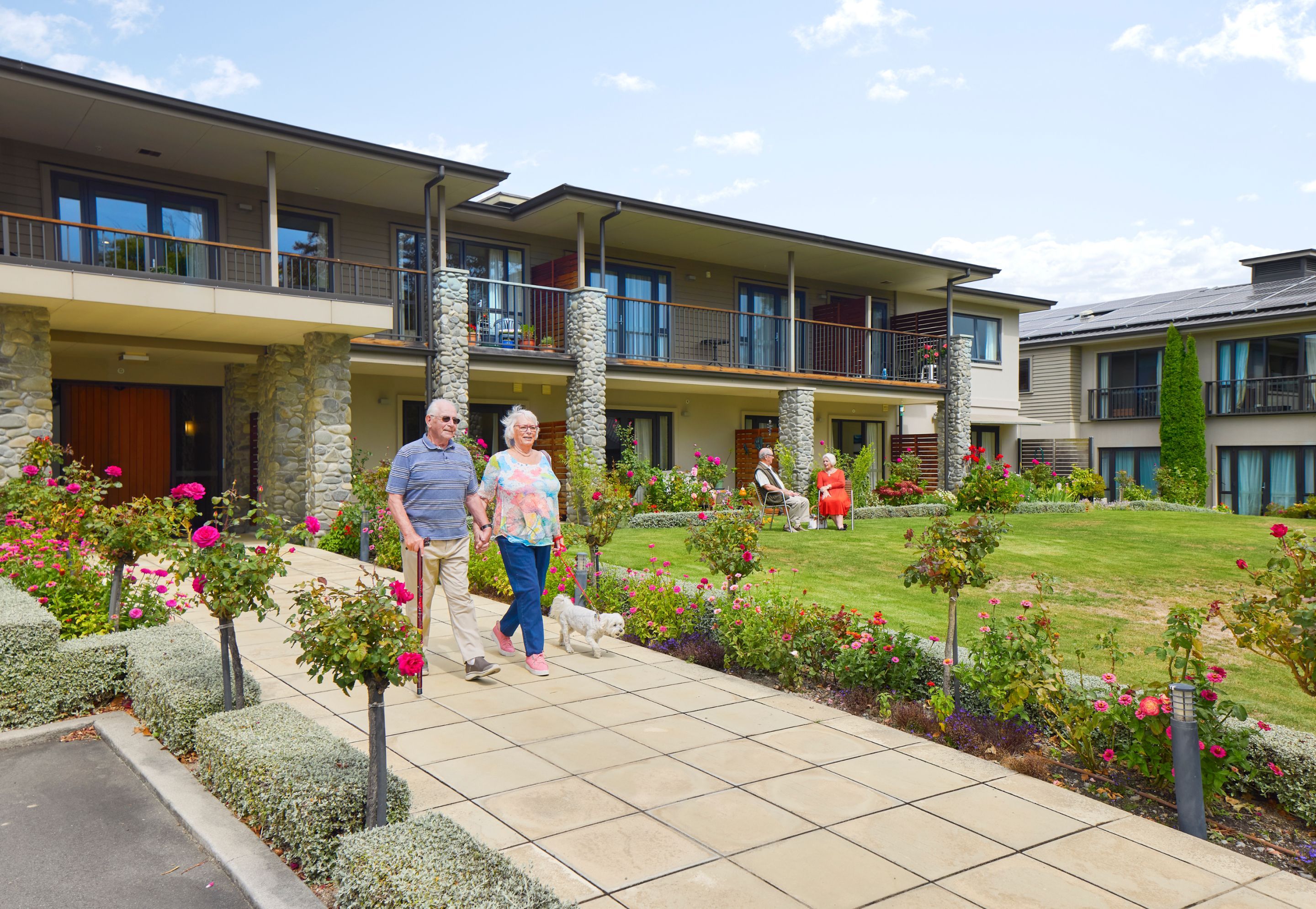 Residents walking through Springlands Village