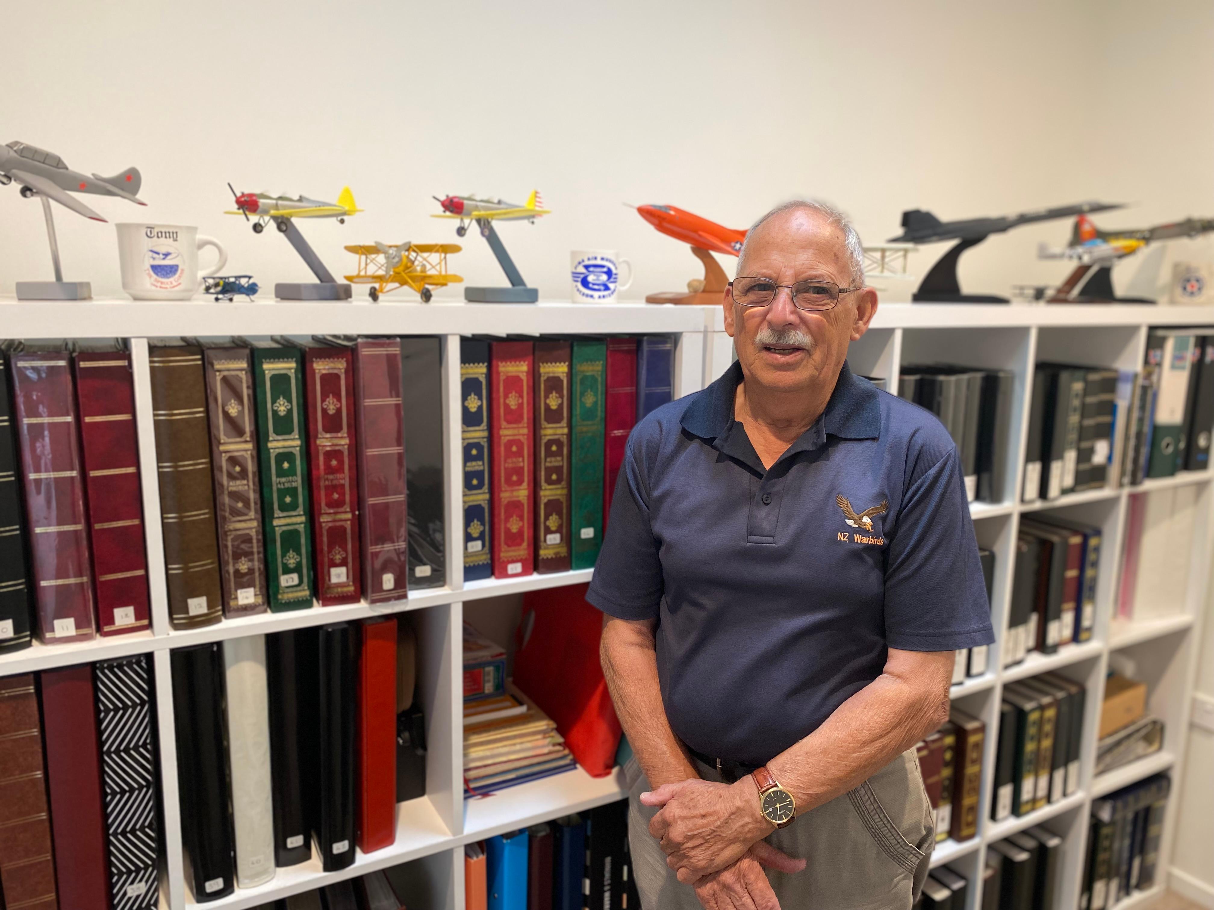 Tony Harsant standing in front his model aircraft collection