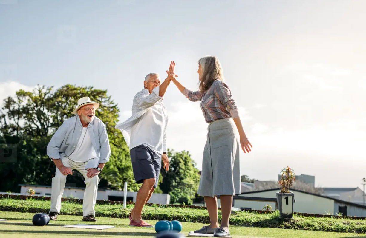 Elderly group playing pétanque outdoors