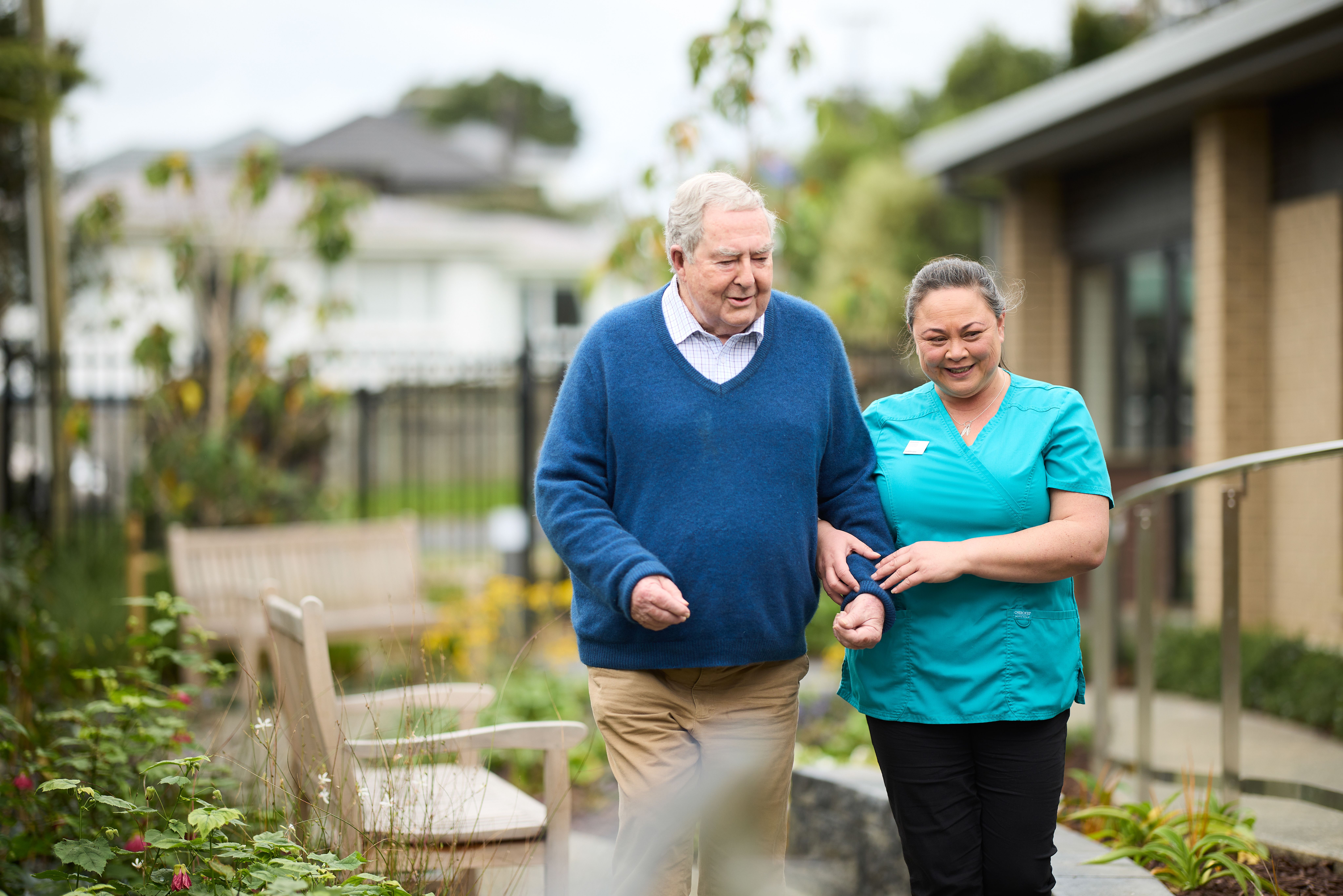 Metlifecare caregiver taking resident for a walk