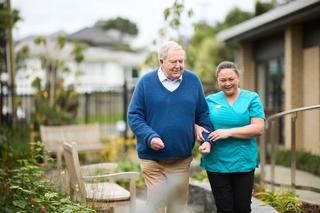 Metlifecare caregiver taking resident for a walk