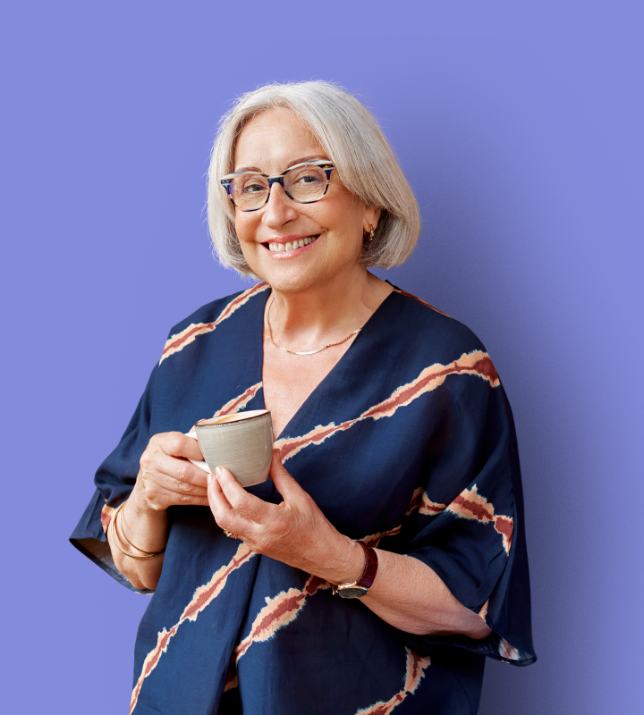 Resident smiling with a cup pf tea