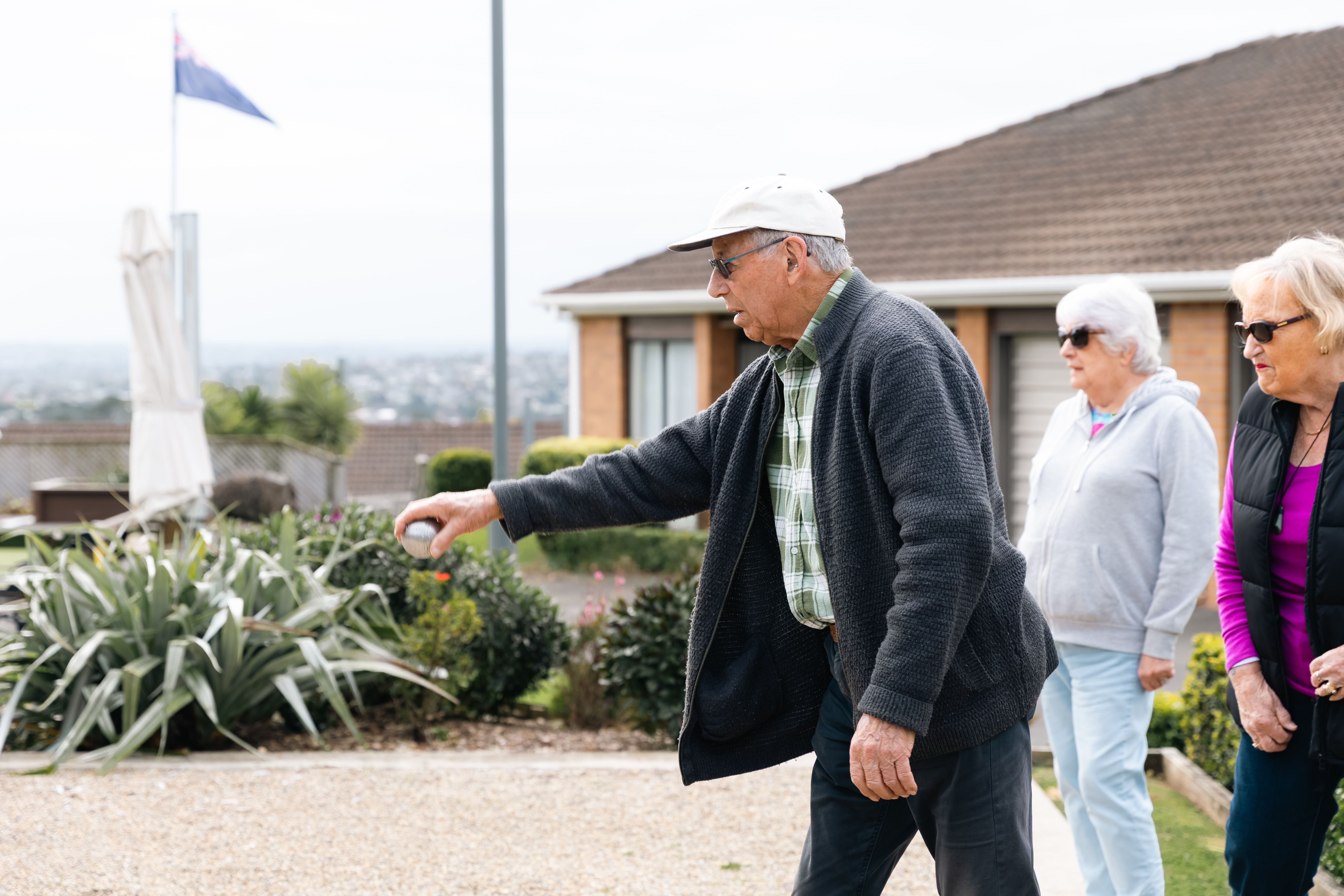 Resident smiling playing petanque