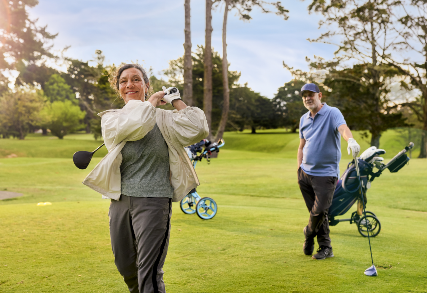 Golfers enjoy a round on the course next to Fairway Gardens village 