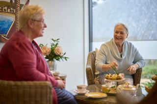 Happy residents having tea