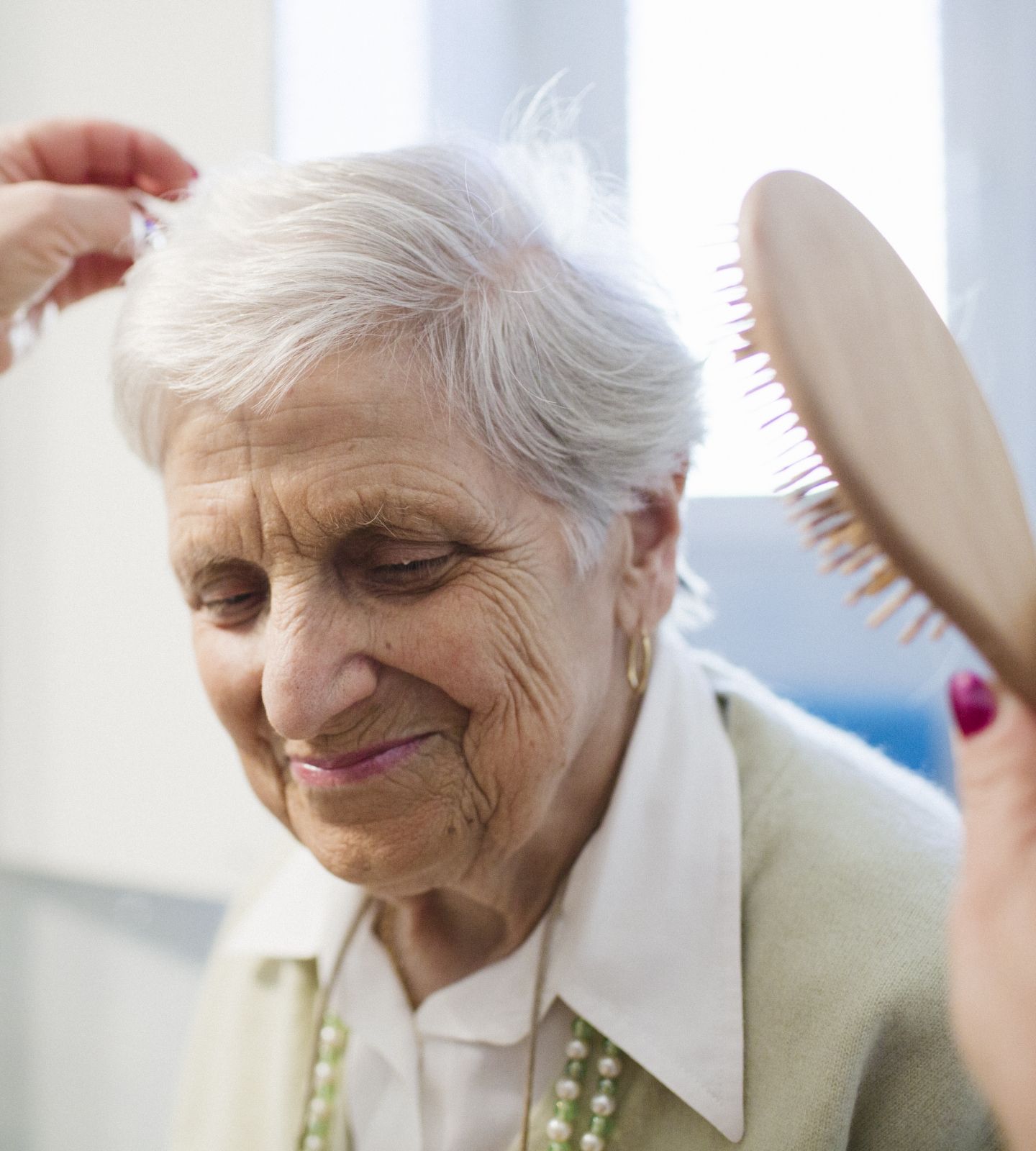 Resident having hair brushed