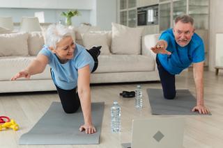 Seniors staying active by practicing a yoga pose