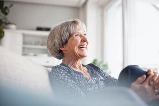 Woman sitting down in her assisted living care suite