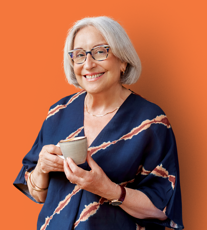 Resident smiling with a cup pf tea