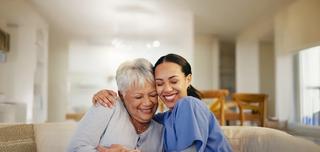 Elderly women with nurse smiling