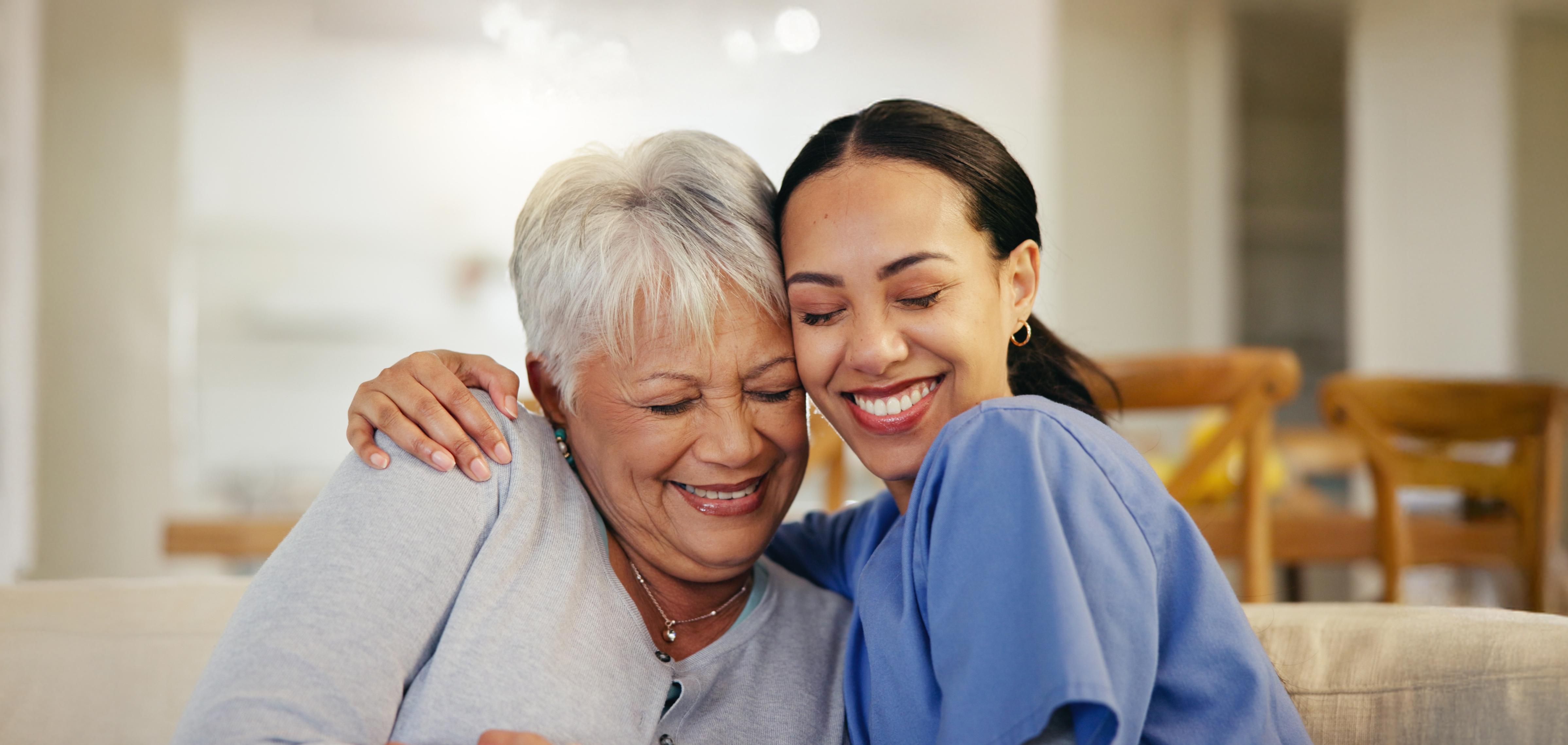 Nurse and resident sharing a warm hug