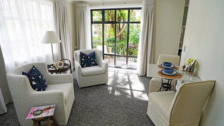 Care Suite lounge with chairs and outlook out to the garden