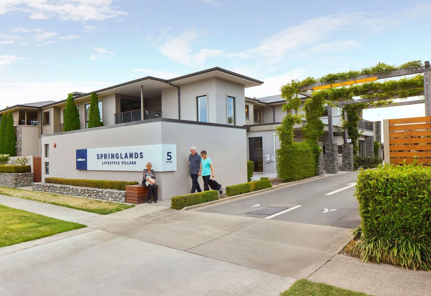 Residents walking outside of Springlands Village