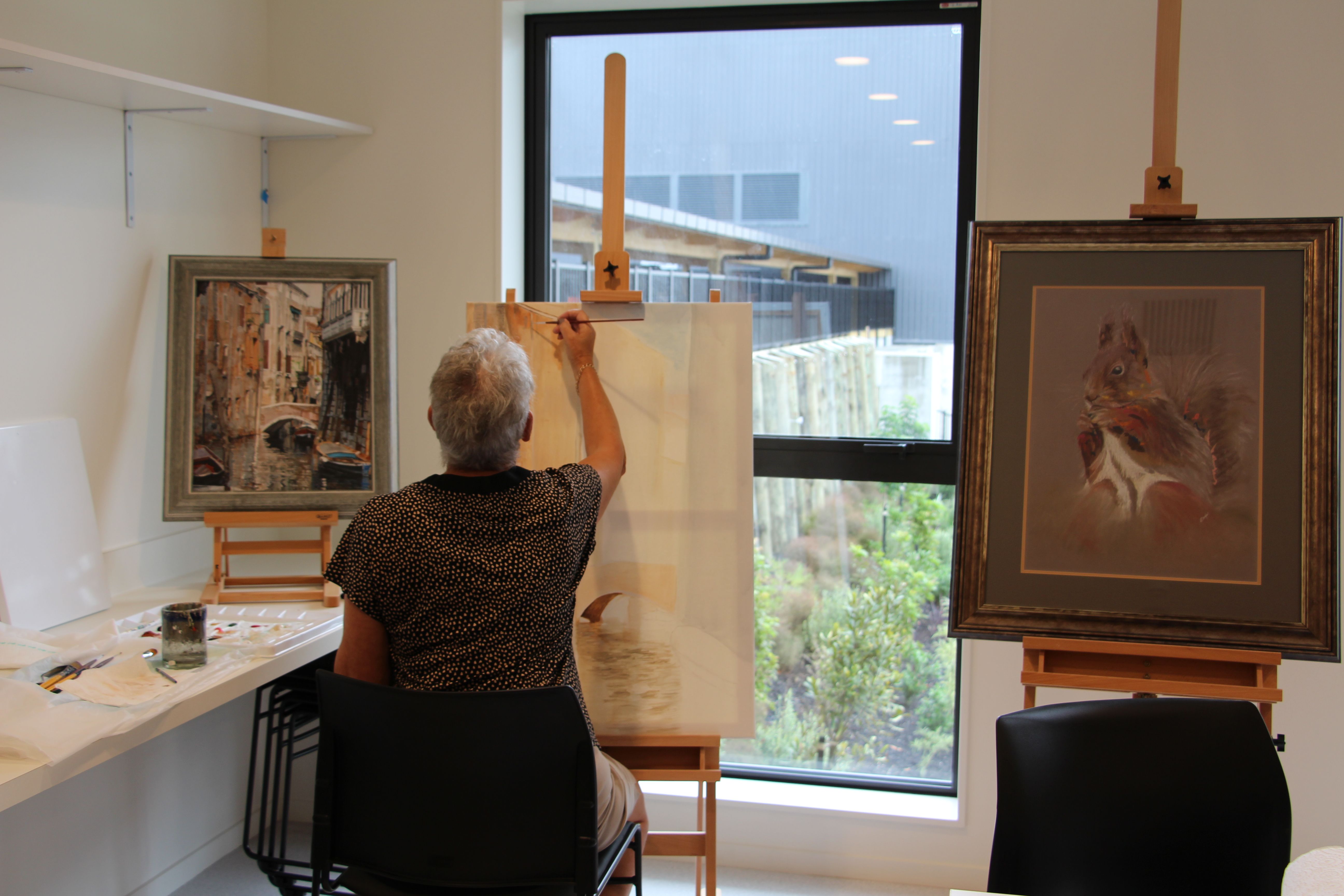 Residents painting in the craft room