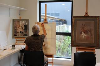Residents painting in the craft room
