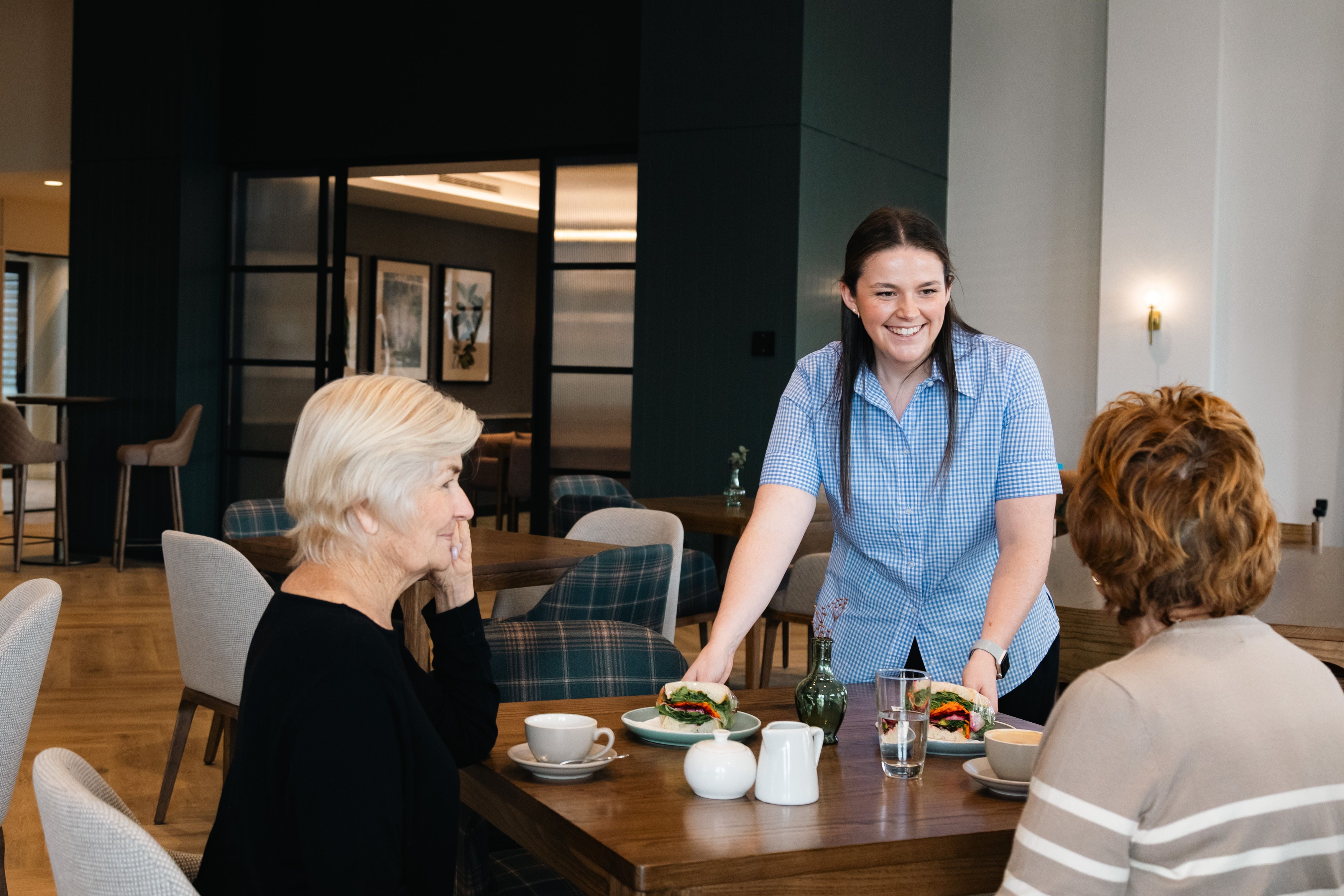 Cafe staff serving residents lunch