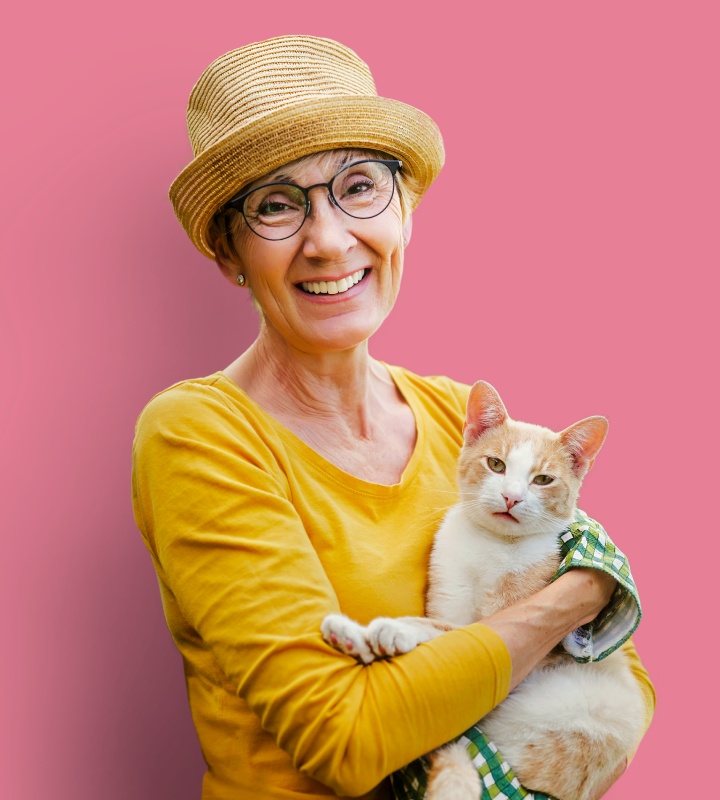 Residents smiling with cat on yellow