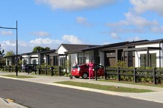 Residents waving to neighbor outside their villa