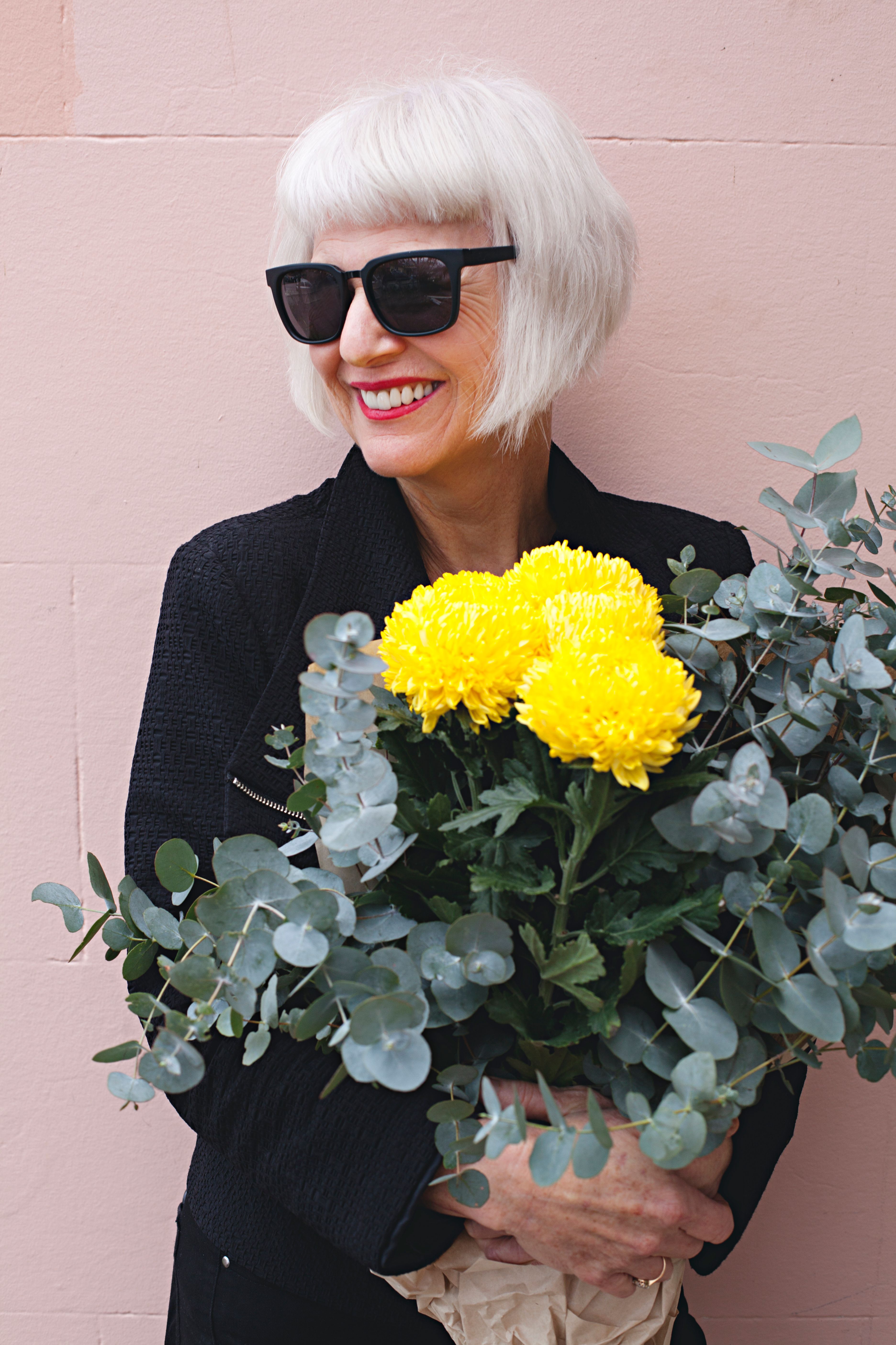 Smiling resident holding flowers