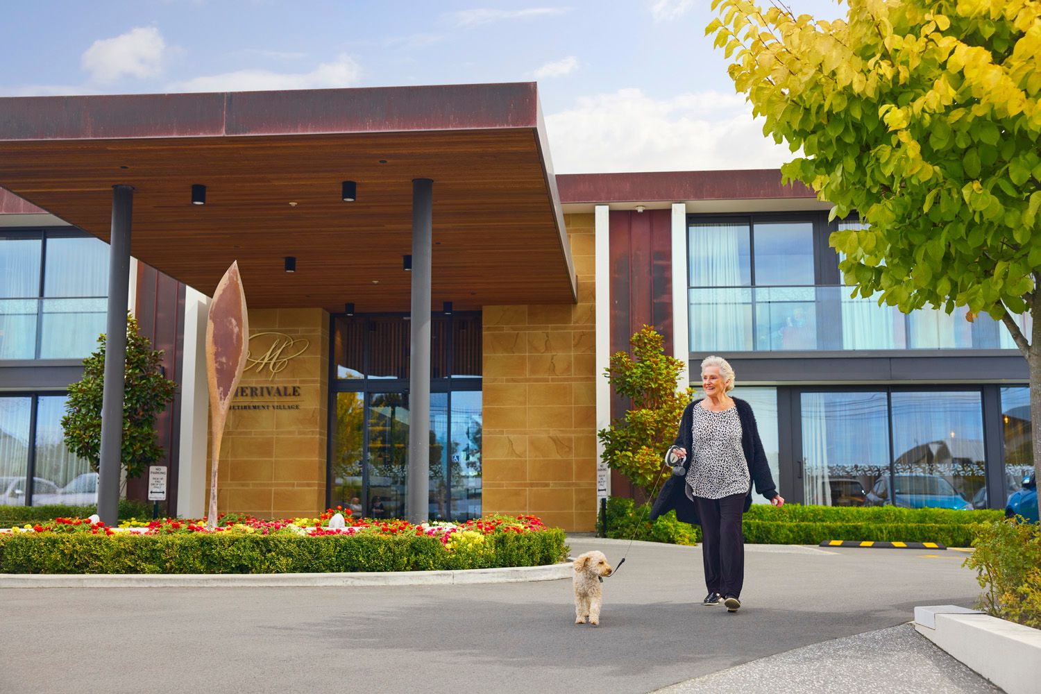 Resident walking her dog outside Merivale Village
