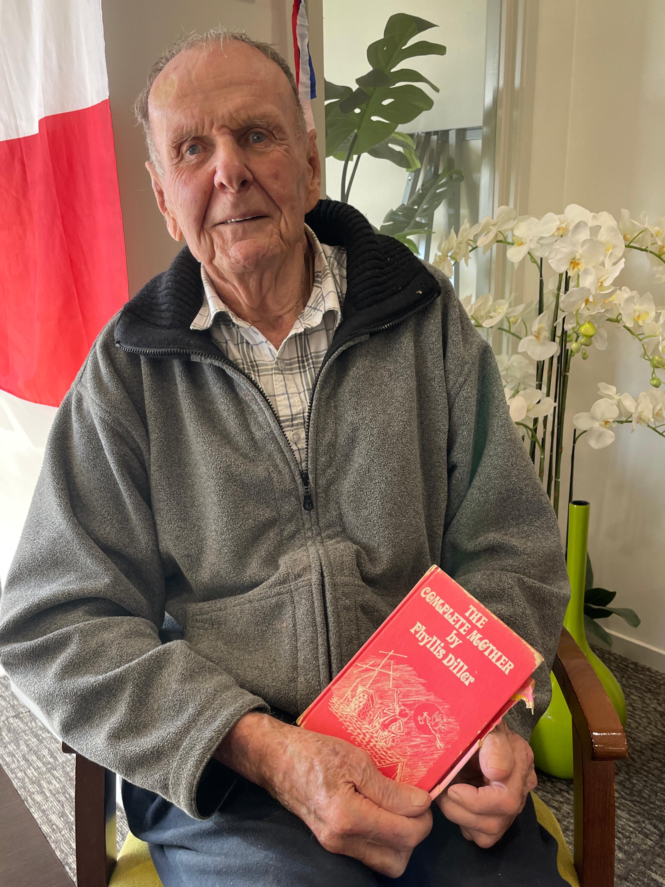 Claude Coumbe with a signed Phyllis Diller book