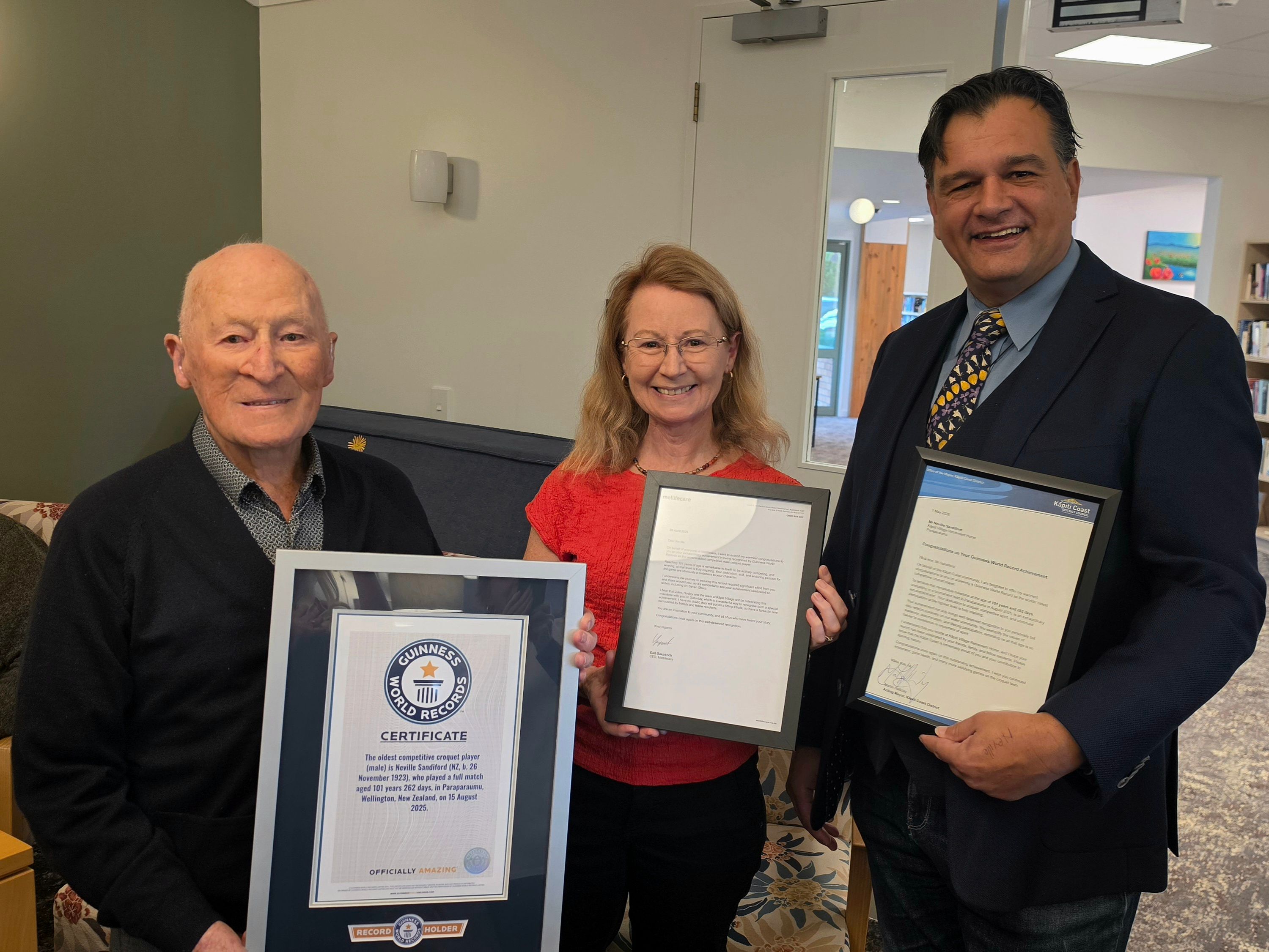 Neville with daughter Maria and Acting Mayor Halliday holding his Guiness World Records certificate